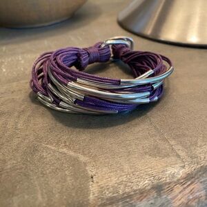 Bracelet made of purple cord with silver accent beads